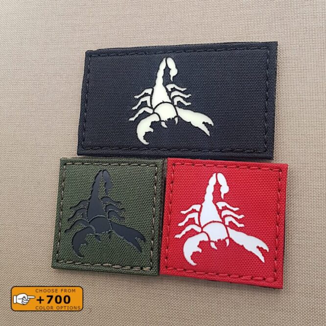 three patches with the image of a scorpion