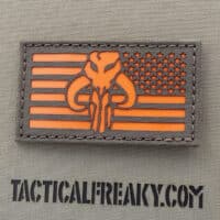 A patch of the Stars Wars Mythosaur in the USA flag with size 2"x3.5"in Ranger Green background with solid Orange feature